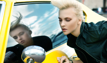 beautiful girl mirroring herself upon a car